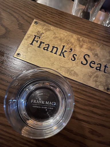 Frank's Seat brass plaque on the bar